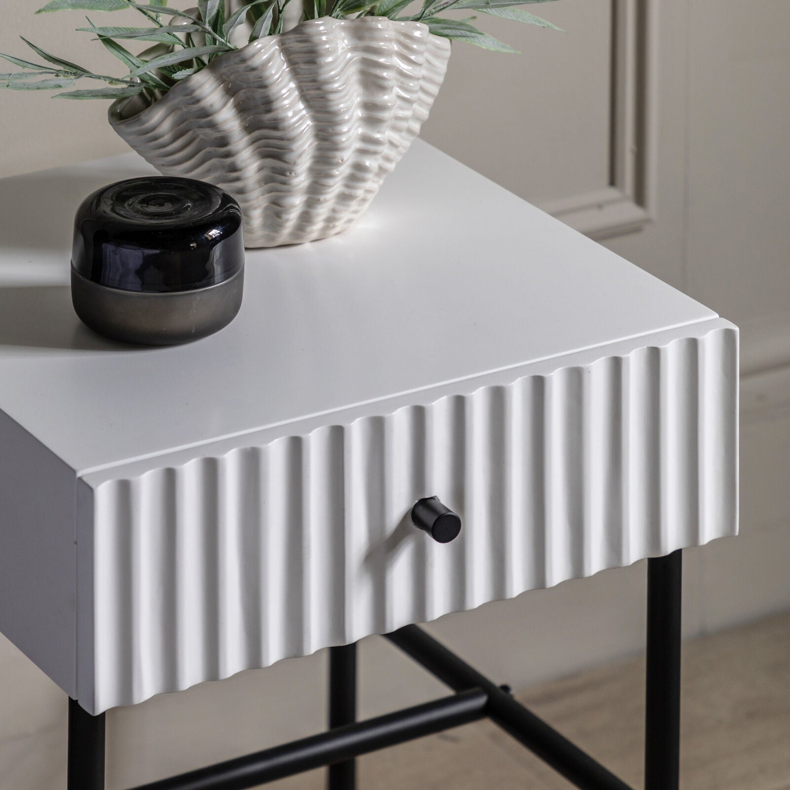 Flute bedside table with drawer in white finish with scalloped fascia and black metal underframe | malletandplane.com