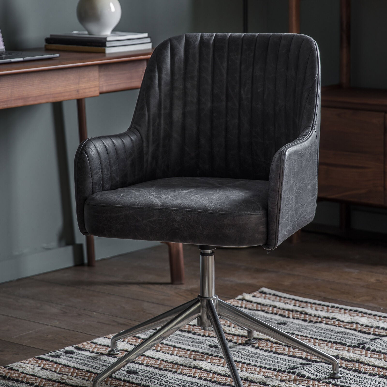 Ray leather upholstered padded swivel chair in antique ebony leather hide | malletandplane.com