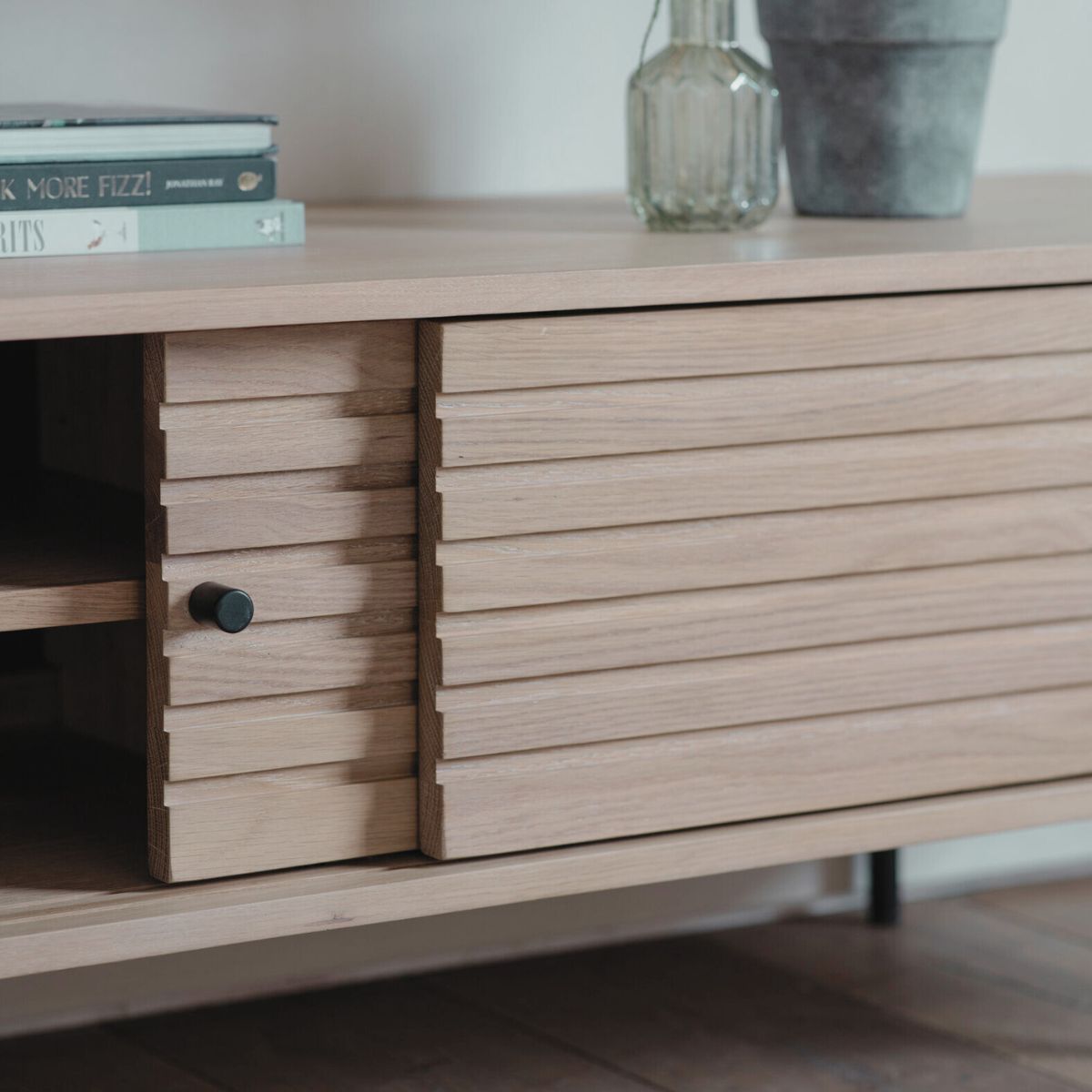 Soja oak and steel media unit with sliding doors and Japandi slatted detailing | malletandplane.com